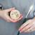 A beauty image of The Masters Brush Cleaner & Preserver in hand with paintbrush.