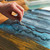 A lifestyle image of Winsor & Newton Colorless Art Masking Fluid Watercolor Medium in use.